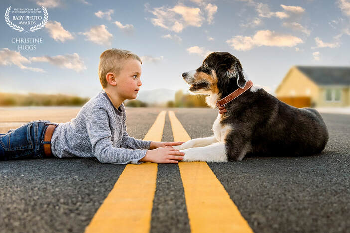 boy and dog laying in the street