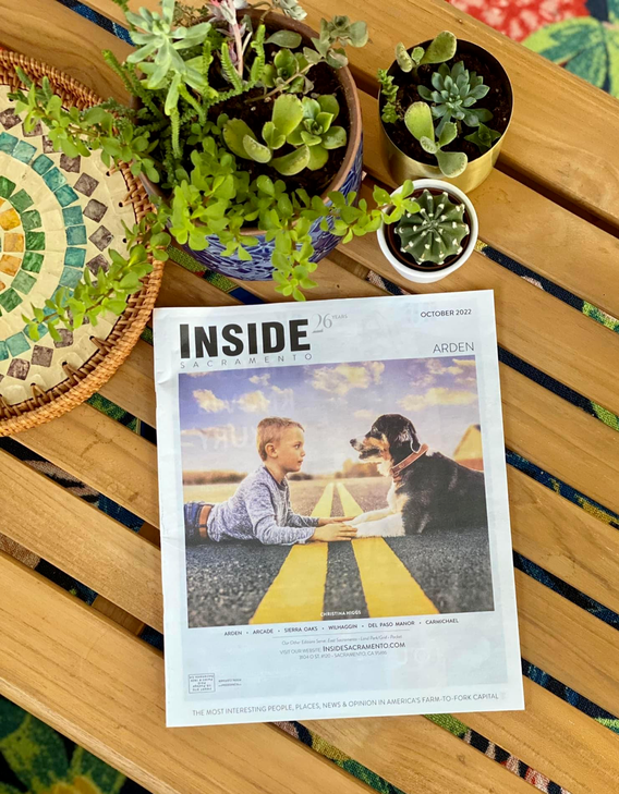 boy and dog laying in the street on the cover Inside Sacramento magazine