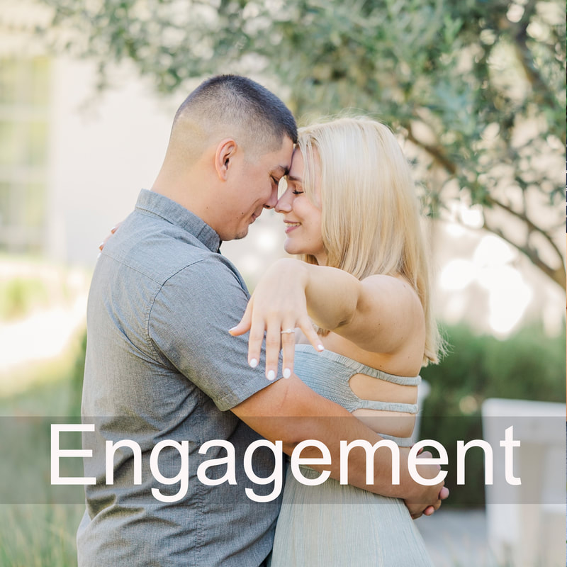 engagement of man and woman with foreheads together holding out hand with engagement ring