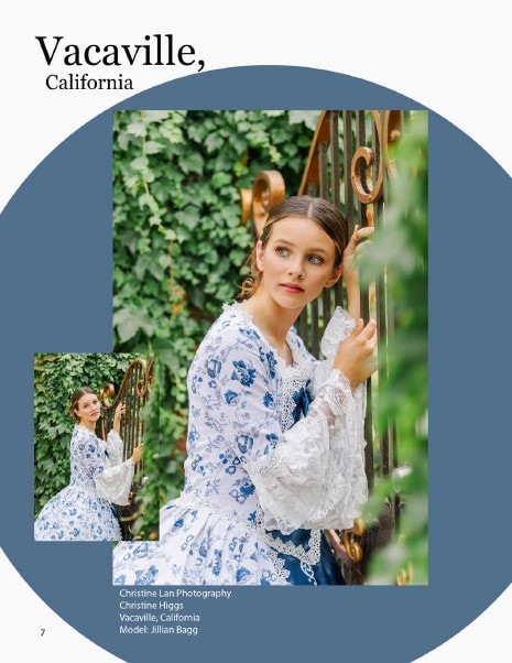 Girl in blue and white Victorian dress holding on to a gold gate looking behind her