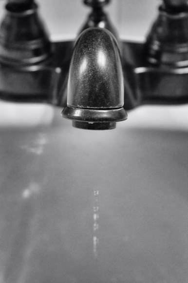 black and white of dripping faucet