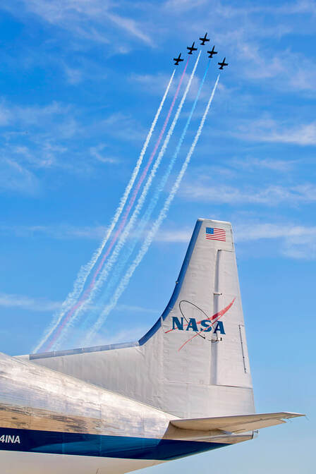 five planes in the air with a Nasa aircraft