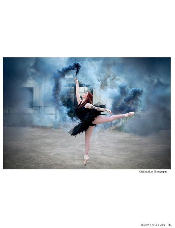 teenage ballet dancer in black tutu holding a blue smoke bomb