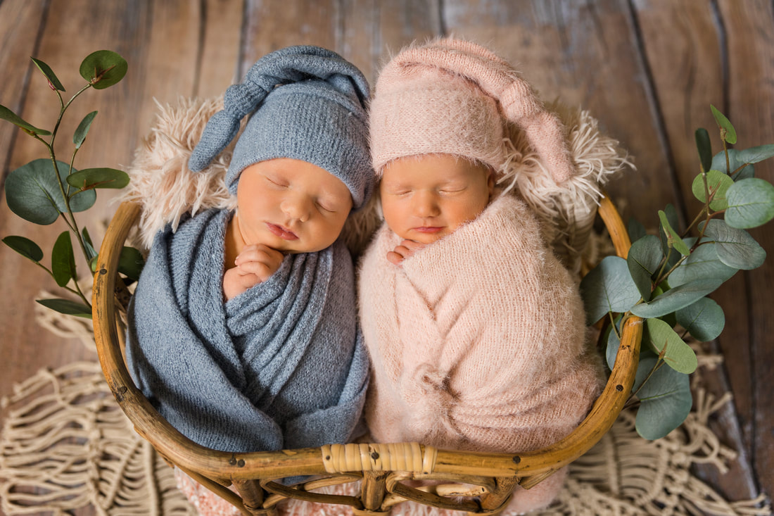Boy Girl Twins wrapped in blankets sleeping in wicker basket