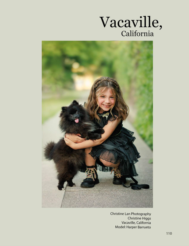 little girl hugging black little dog