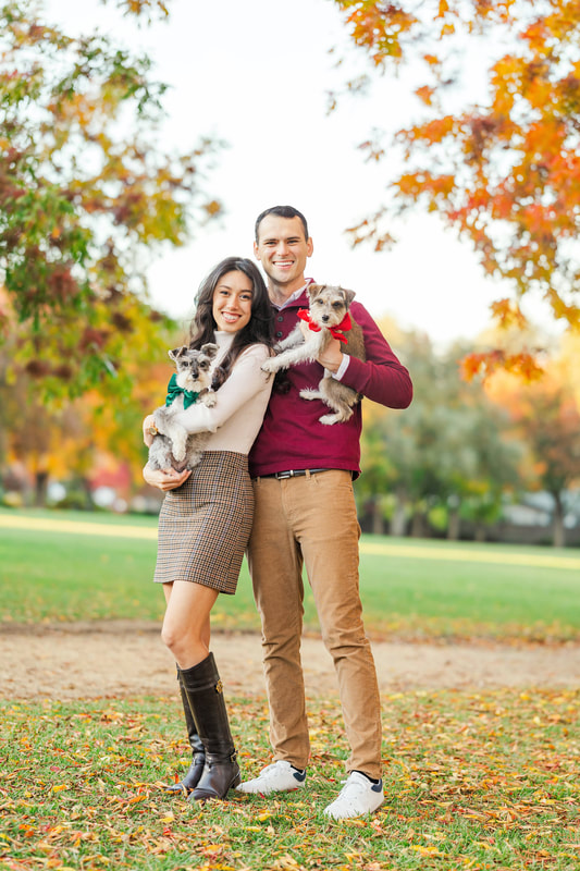 Young male and female couple holding their dogs
