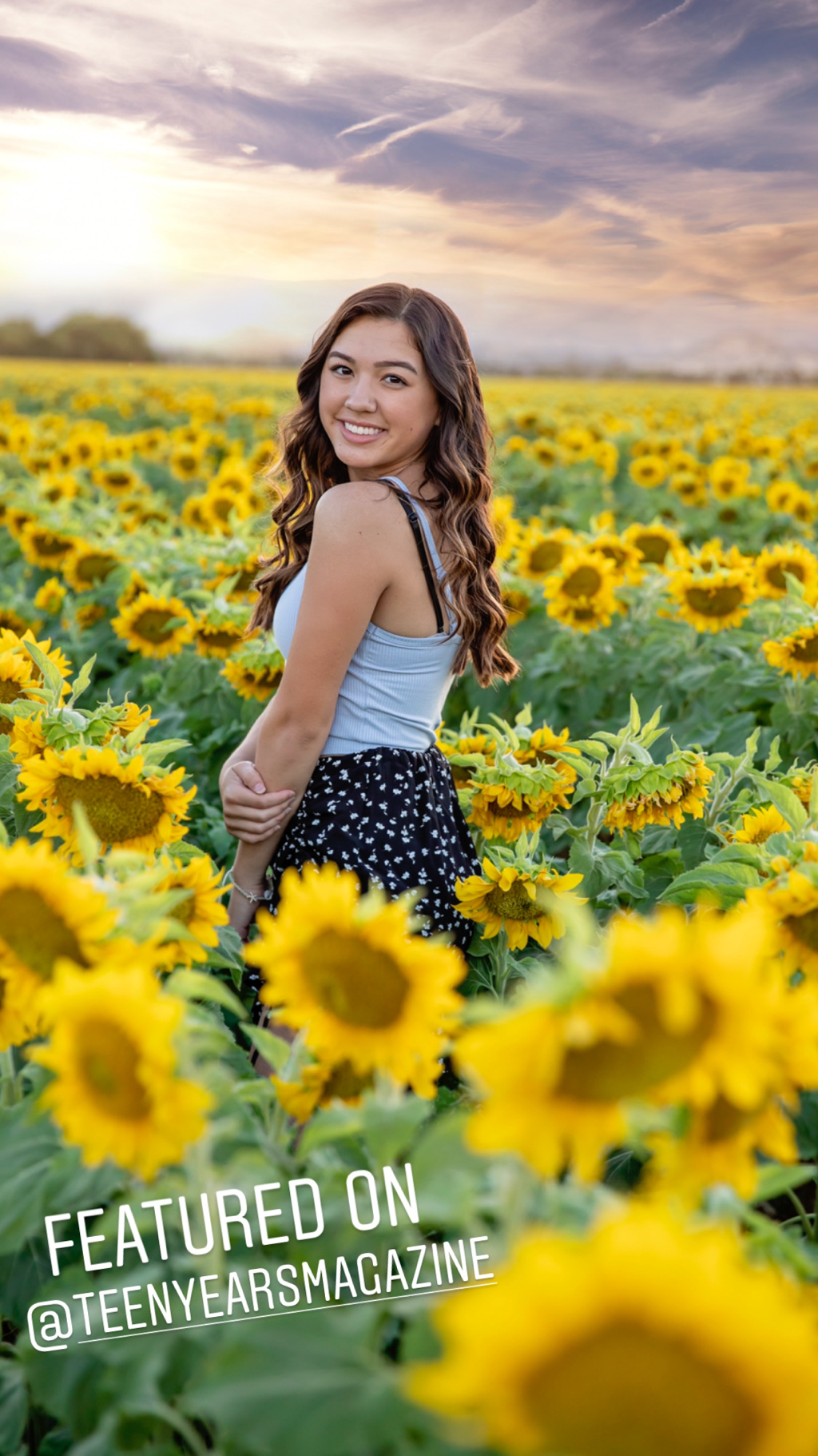 teenage girl with long brown hair in sunflower field