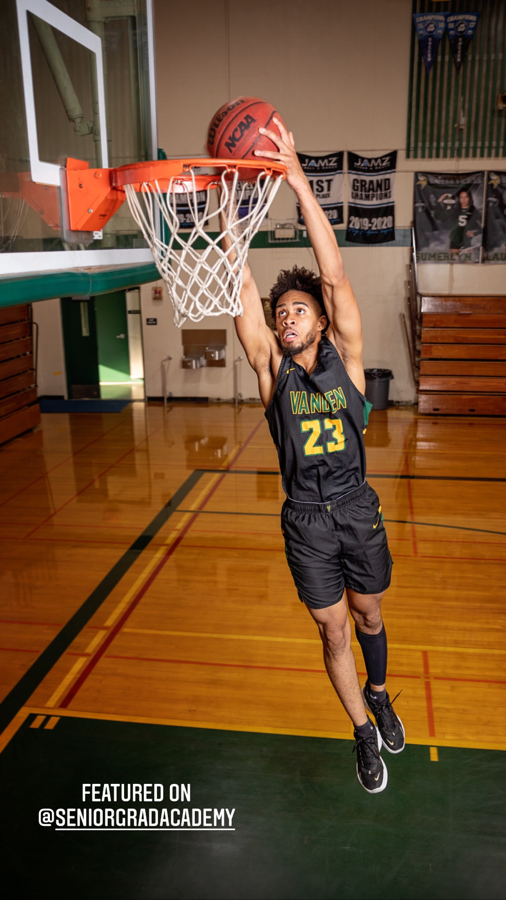 teenage boy shooting a basketball into the hoop at Vanden High School
