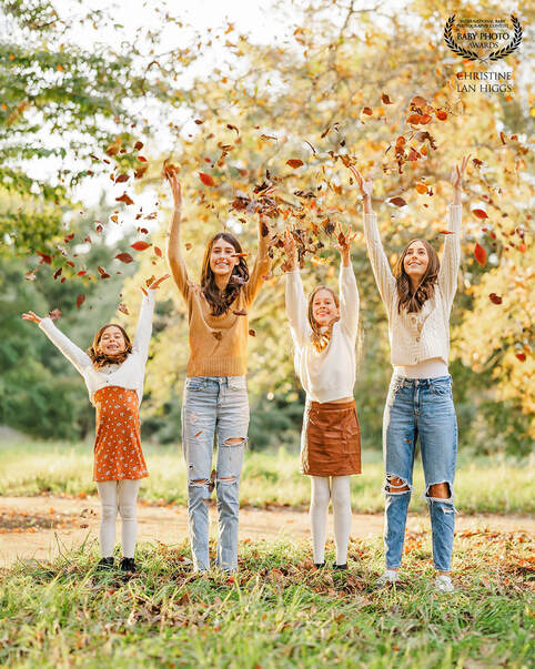 4 sister under the age of 16 throwing leaves in the air