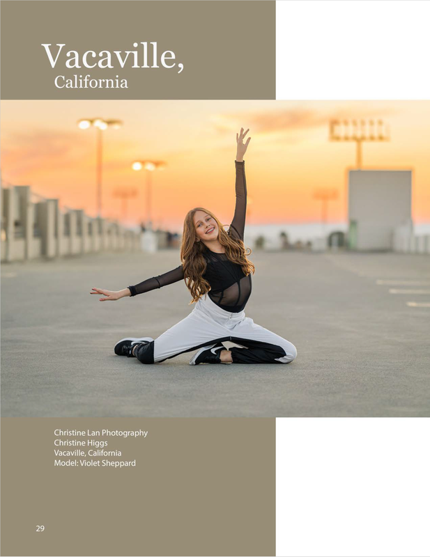 Girl in black leotard and white pants sitting on parking garage floor with arms up at sunset